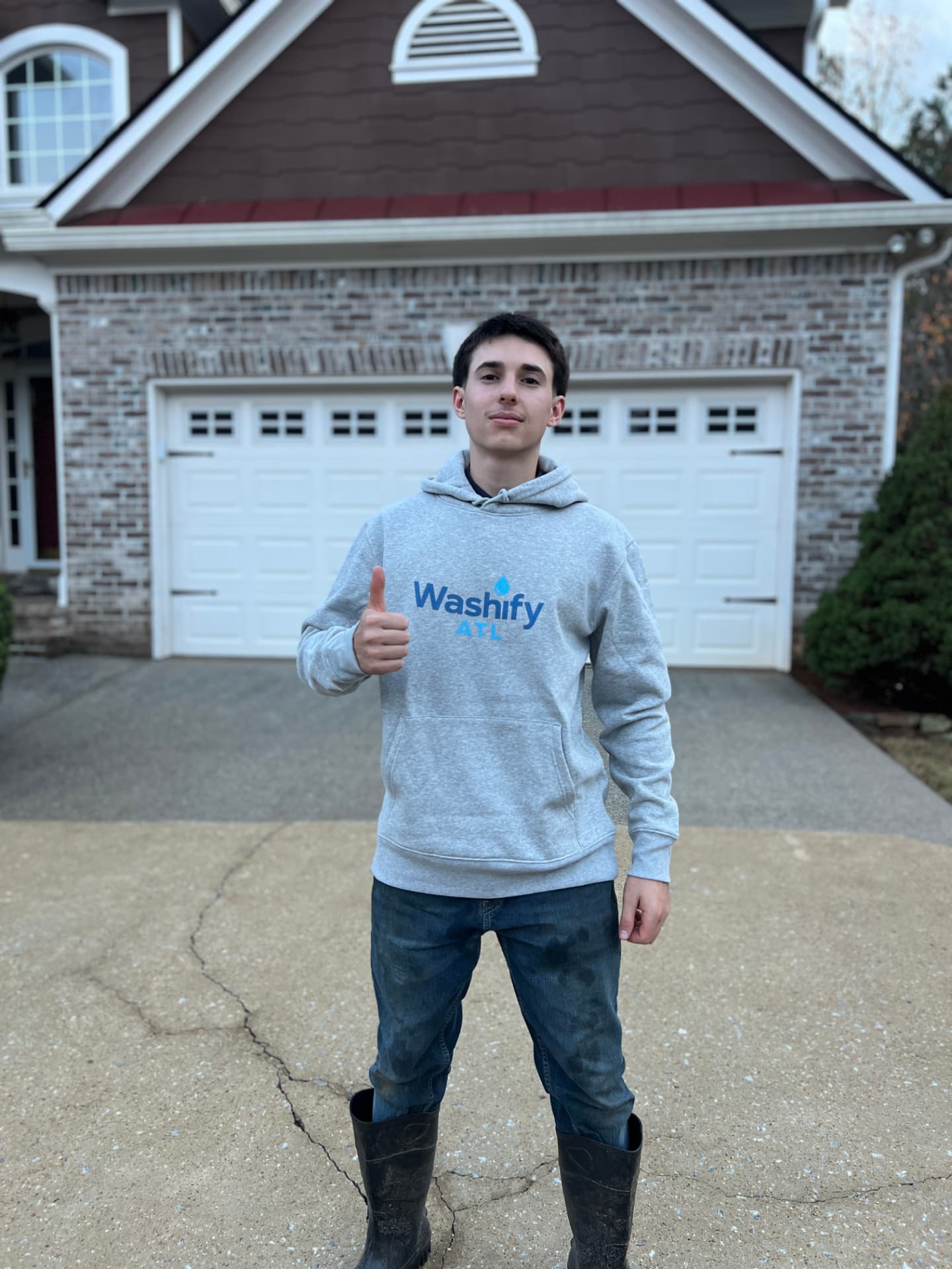 Matteo, owner of WashifyATL, in front of a freshly pressure washed home