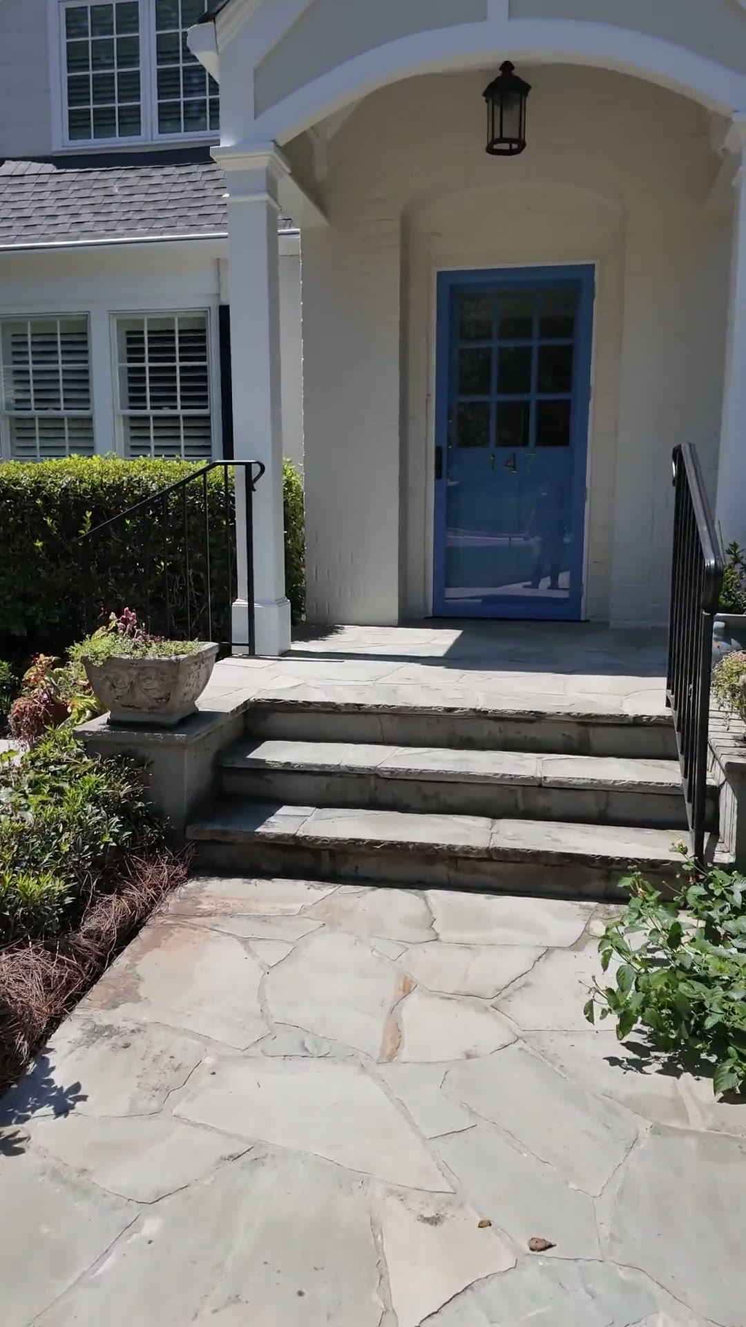 Freshly cleaned front steps and stone walkway at a WashifyATL job