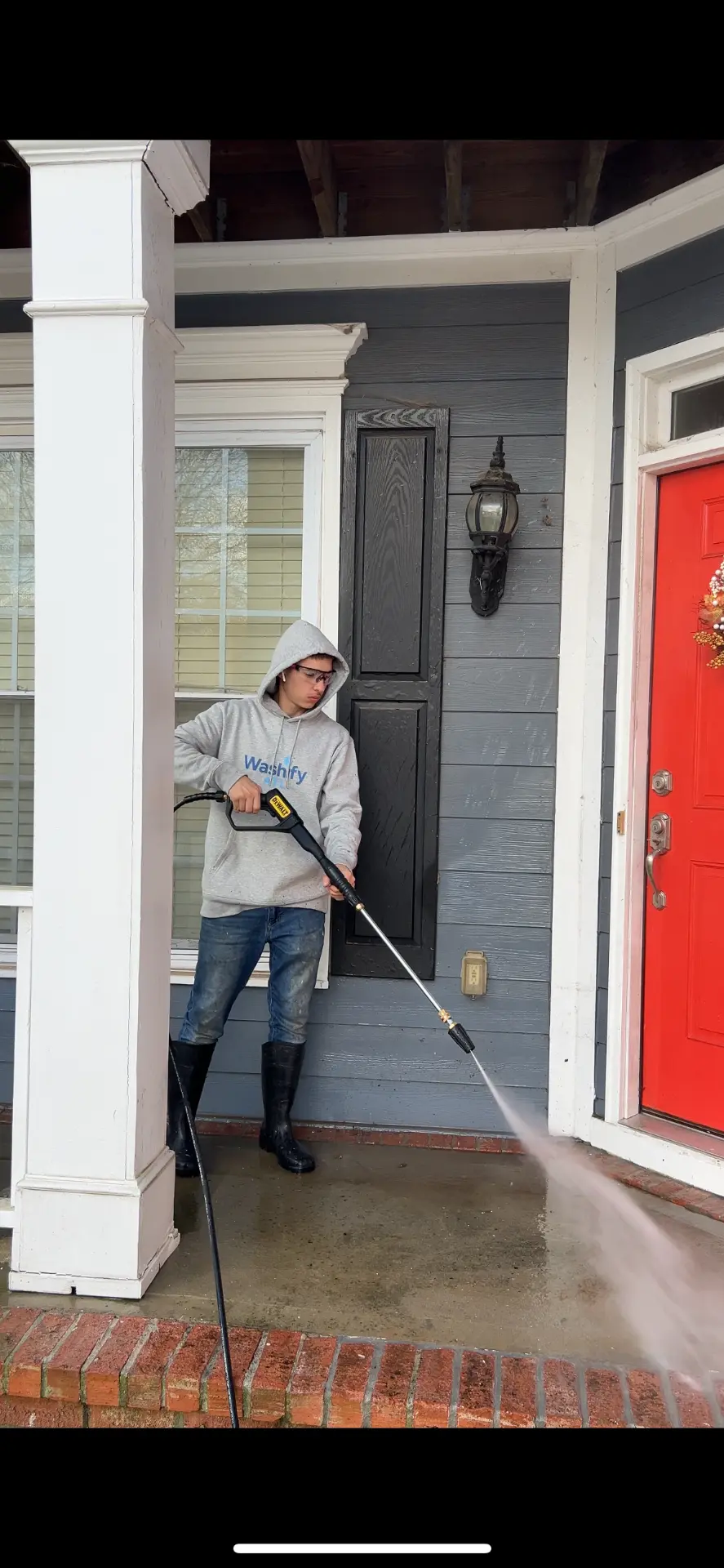 Soft washing the exterior siding of a home in Avondale Estates